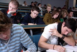 Students writing notes in a lecture
